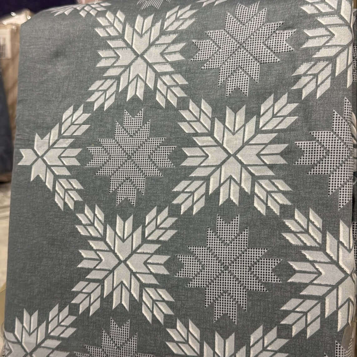 Aarniva geometric cotton bedsheet set design featuring silver snowflake pattern on a charcoal background.