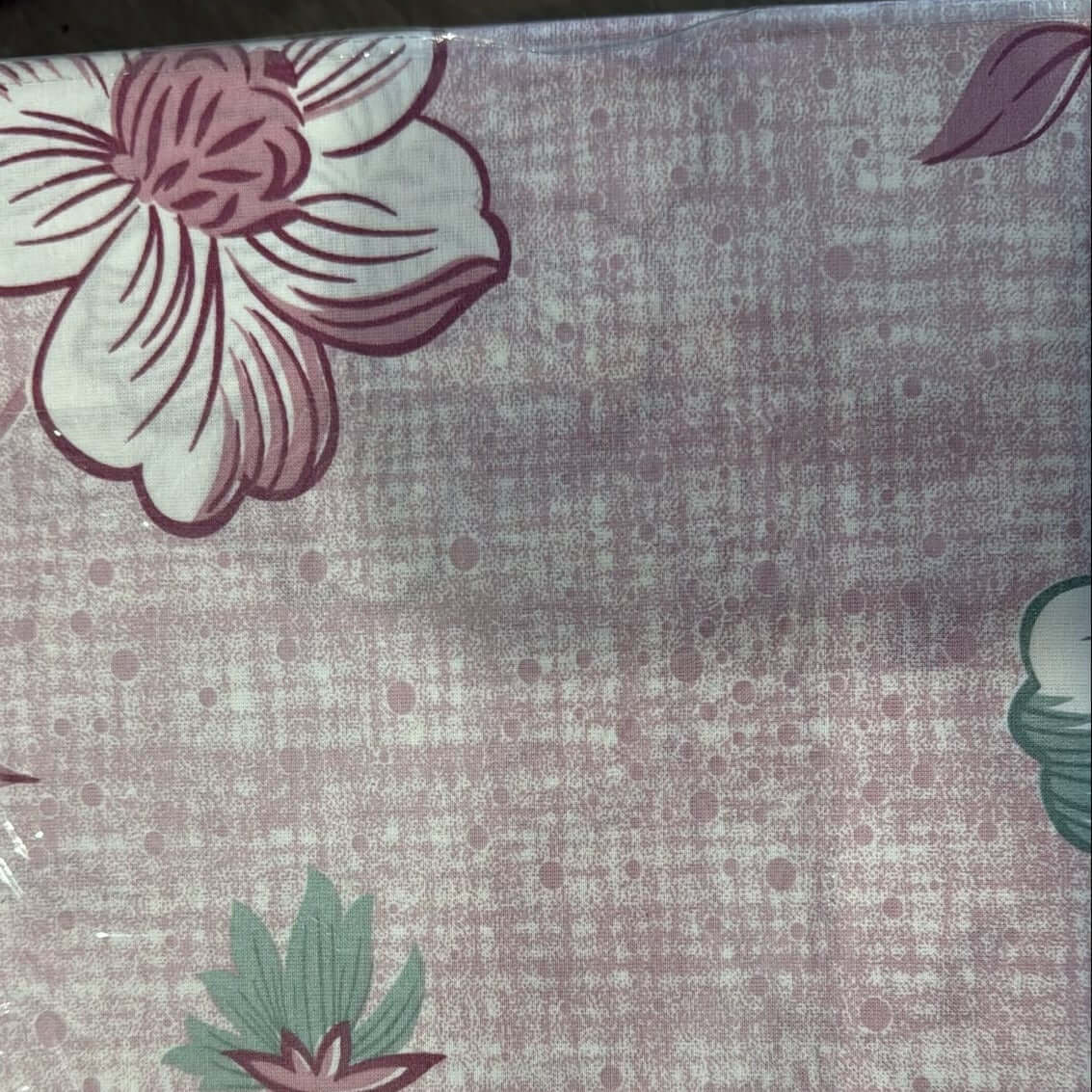 100% cotton floral bedsheet set featuring a pink blossom design on a textured background.