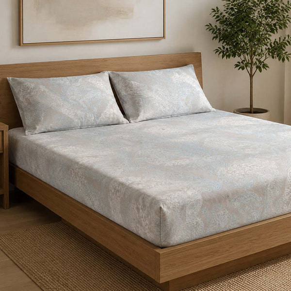 Aarniva 100% Cotton Paisley Bedsheet Set in ivory blue color on a bed, showcasing soft and breathable fabric.