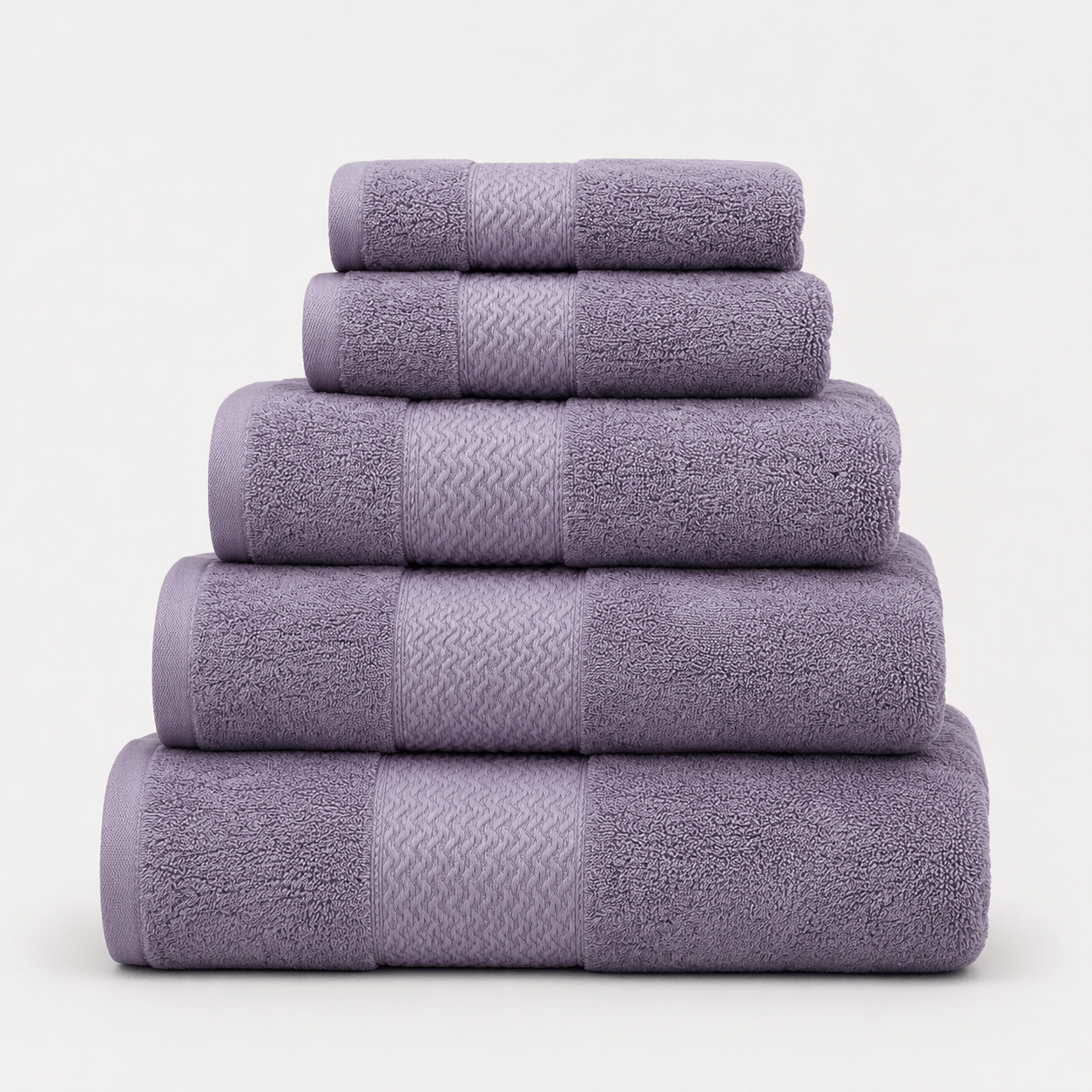 Aarniva cotton jacquard towel set in purple, displaying a 5-piece stacked arrangement, soft and absorbent.