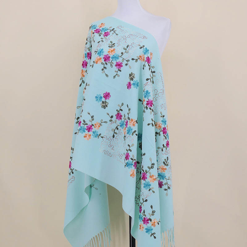 Aarniva embroidered faux cashmere shawl in turquoise blue, featuring floral tassel design for a warm, elegant look.