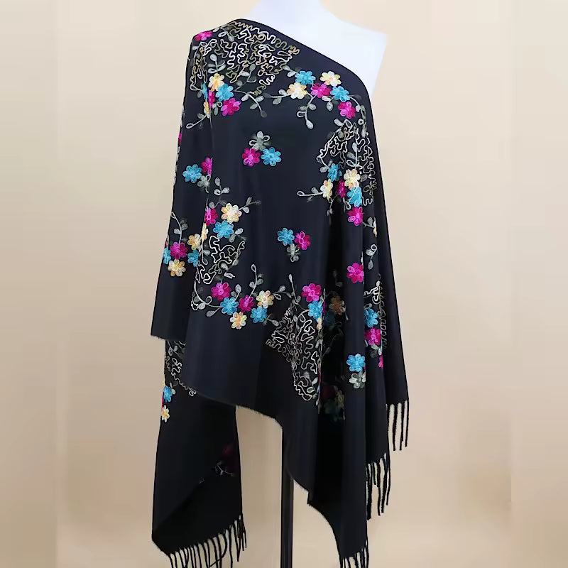 Aarniva embroidered faux cashmere shawl featuring colorful floral tassel design on a black wrap scarf.