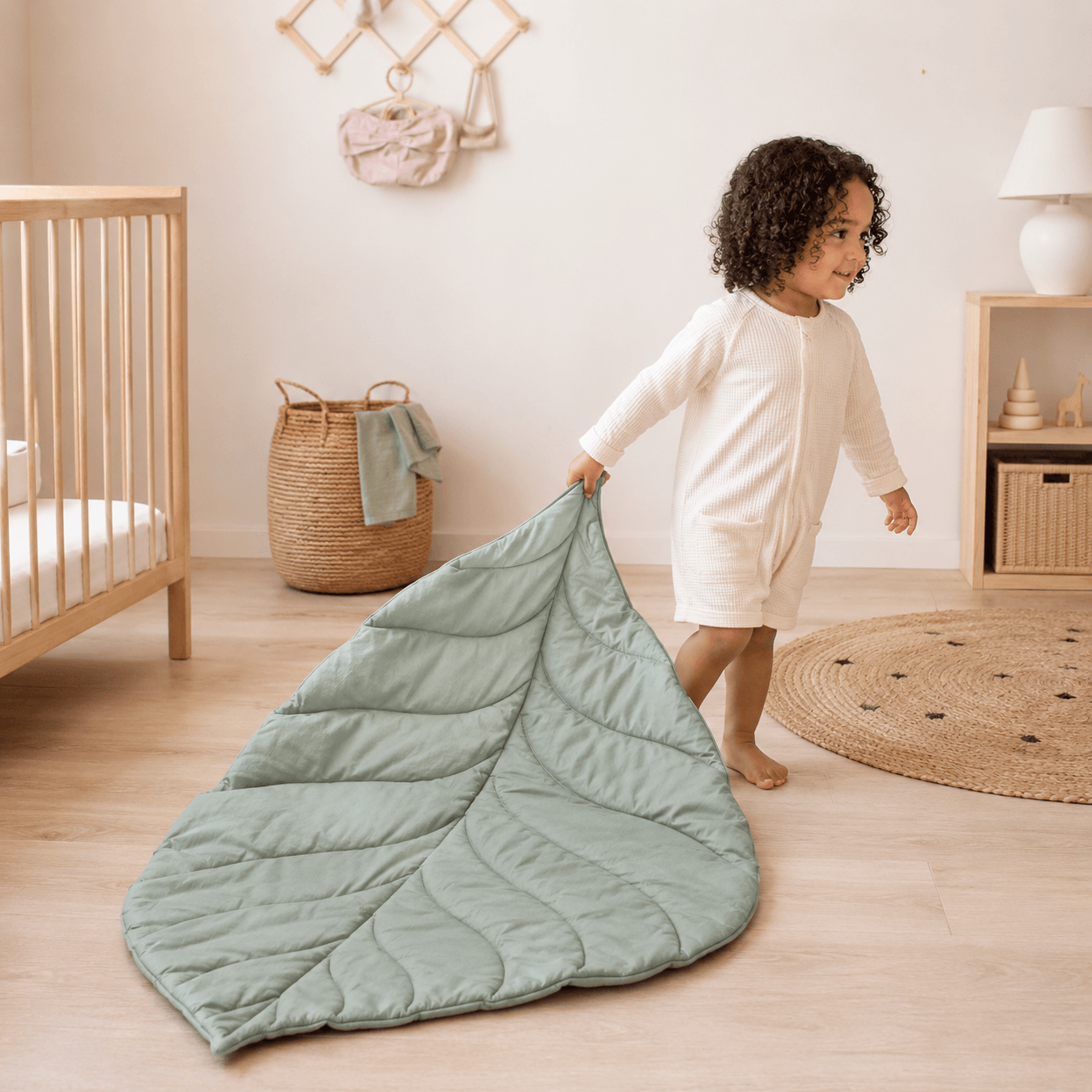 Child playing with Aarniva Leaf-Shaped Quilted Baby Play Mat in a cozy nursery setting.