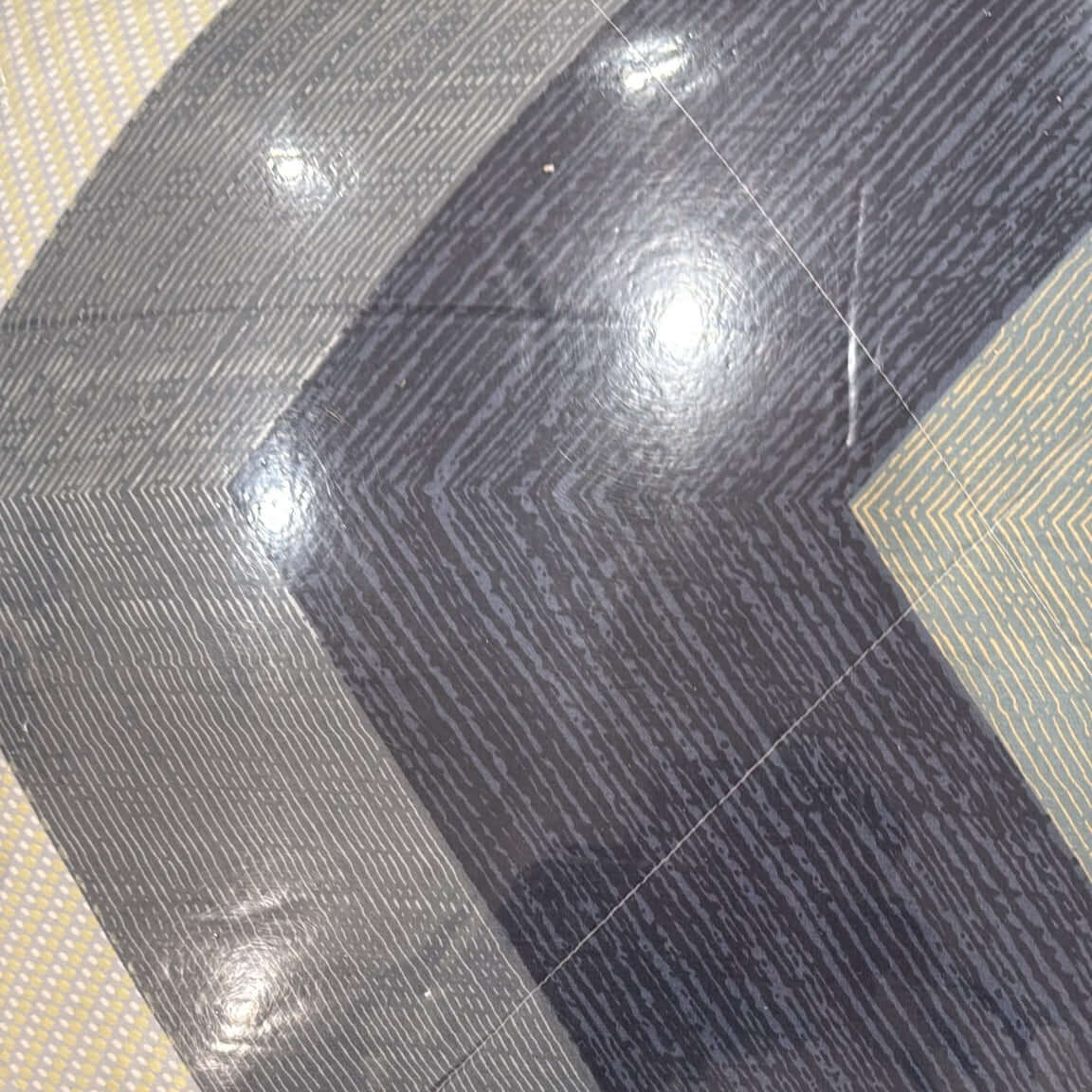 Aarniva Breathable Polyester Midnight Chevron Comforter Set pattern showing modern chevron design on a floor surface.