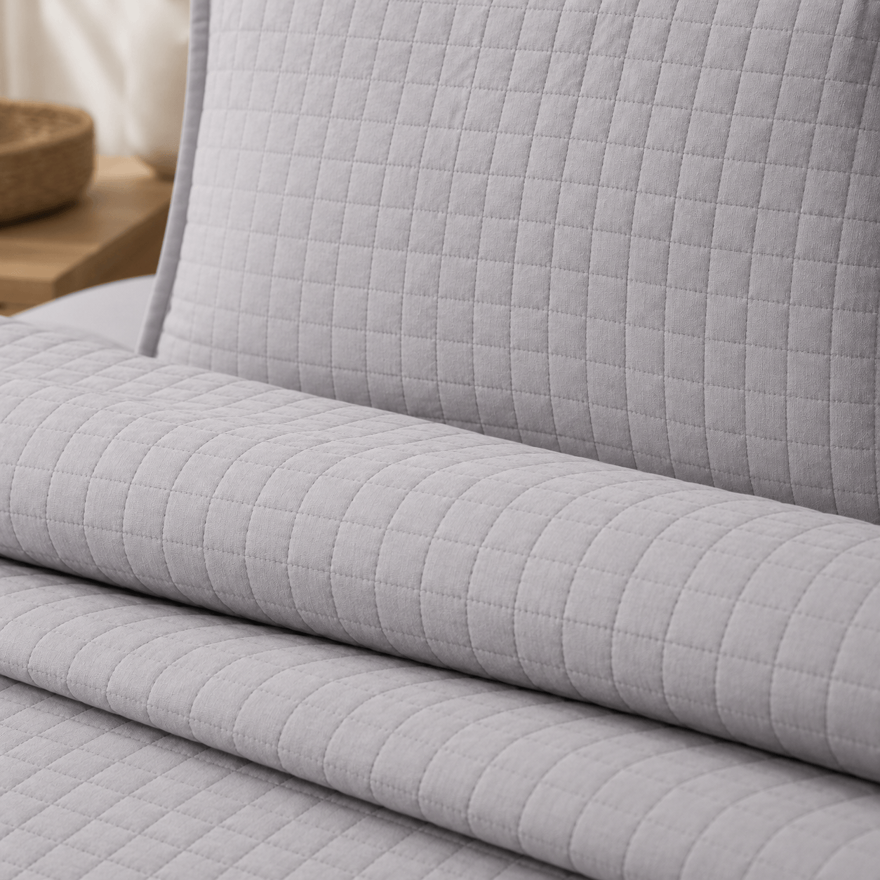 cool grey quilted bedding set showing soft, lightweight fabric and subtle stitched grid pattern.