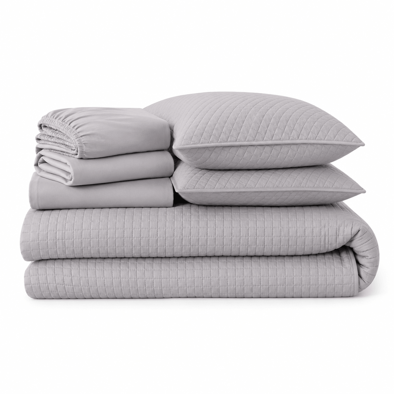 Aarniva Quilted Bedding set in cool grey featuring soft quilt and matching pillows stacked together.