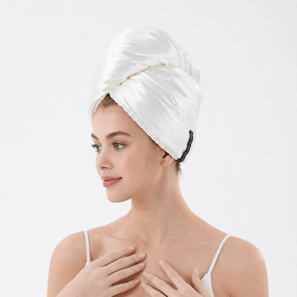 Aarniva Satin & Microfiber Hair-Drying Turban | Soft & Quick-Drying in Bright White on a model's head after a shower.