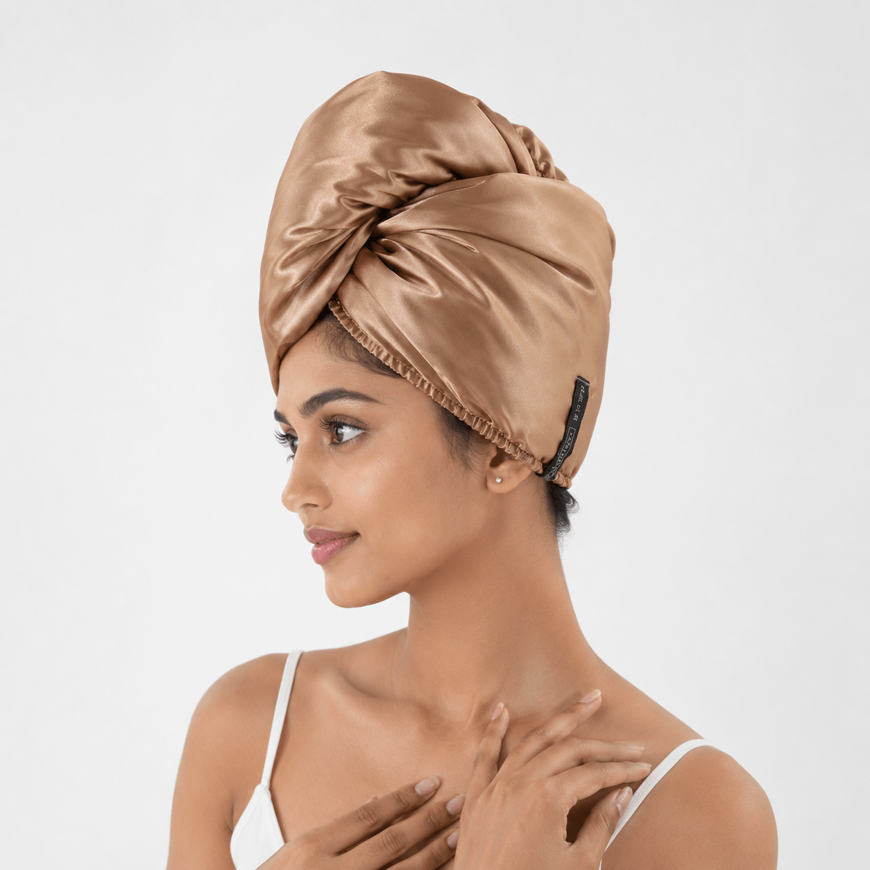 Aarniva satin microfiber hair drying turban in brown, worn stylishly, showcasing smooth and soft comfort.
