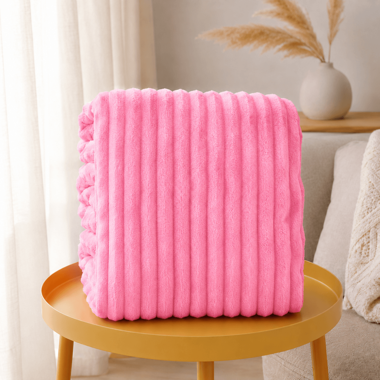 Aarniva Soft Flannel Throw Blanket in bright pink with ribbed texture, displayed on a table for cozy home decor.