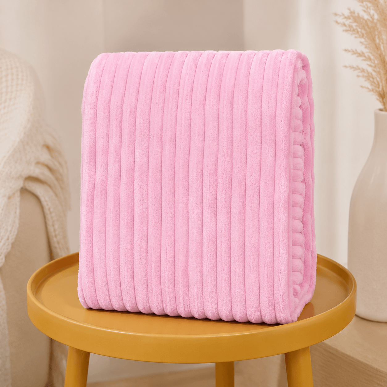 Aarniva Soft Flannel Throw Blanket in baby pink with ribbed texture, ideal for cozying up in any room.