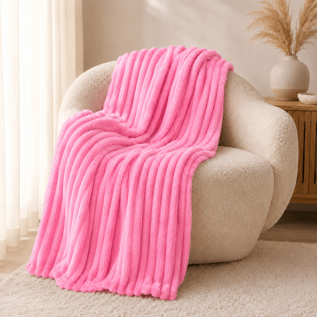 Aarniva Soft Flannel Throw Blanket in bright pink with ribbed texture draped over a cozy chair, ideal for warmth and style.