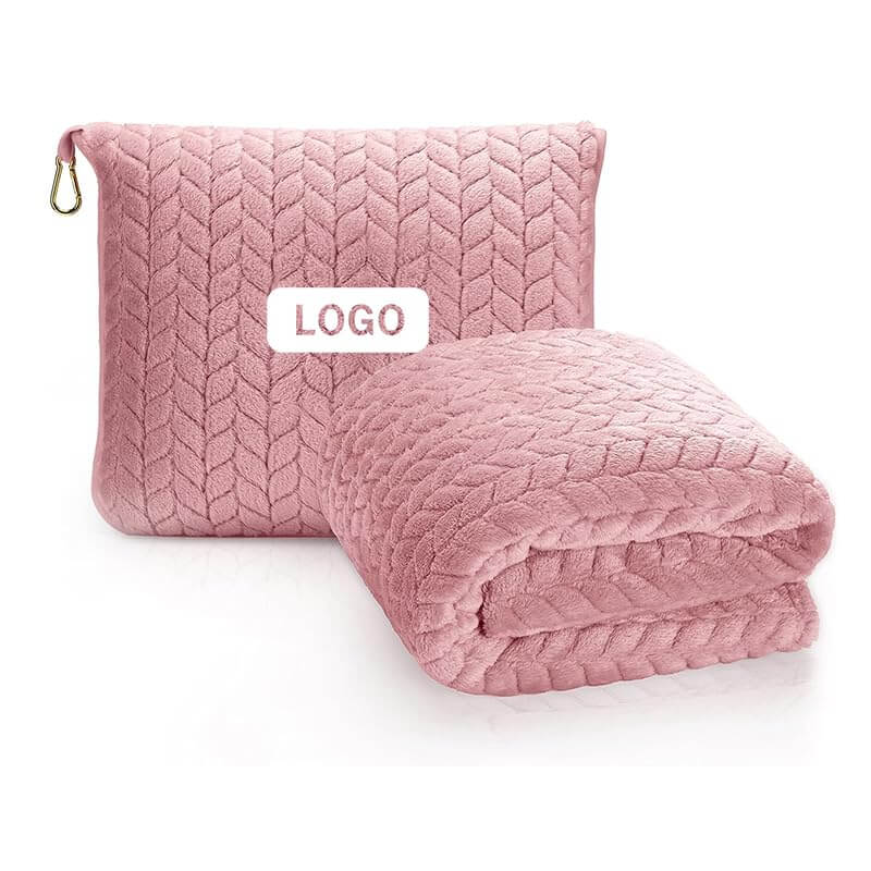 Luxurious 2-in-1 travel blanket and pillow set in pink with quilted pattern and storage bag for airplane travel comfort.