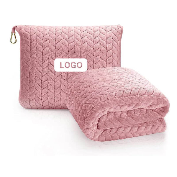 Luxurious 2-in-1 travel blanket and pillow set in pink with quilted pattern and storage bag for airplane travel comfort.