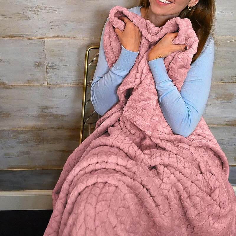 Luxurious 2-in-1 travel blanket and pillow set in pink color, quilted pattern, providing comfort and warmth.