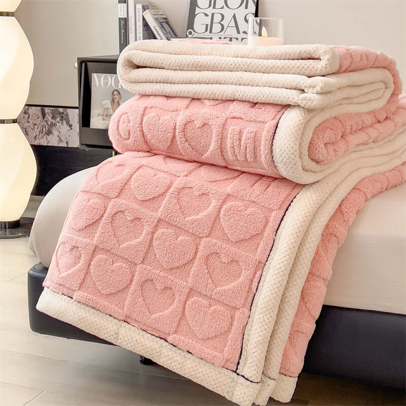 Multifunctional coral fleece blanket in pink with heart patterns, ideal for cozy scenes and modern home decor.