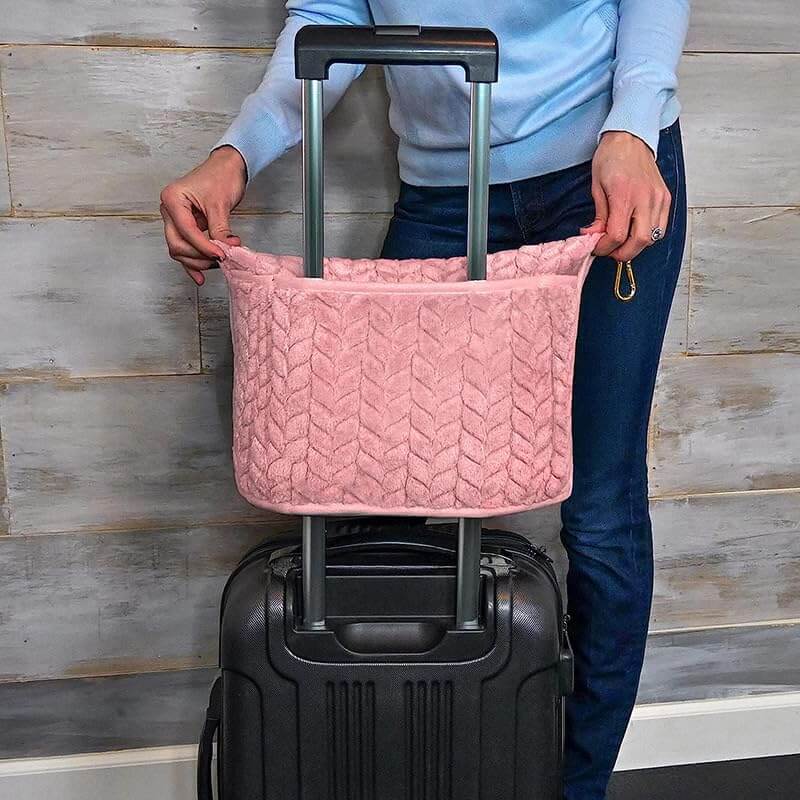 Luxurious 2-in-1 travel blanket and pillow set in pink fabric attached to suitcase handle.